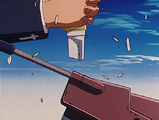 Wolfwood shatters Vash's throwing knife while attempting to attack one of the robots.